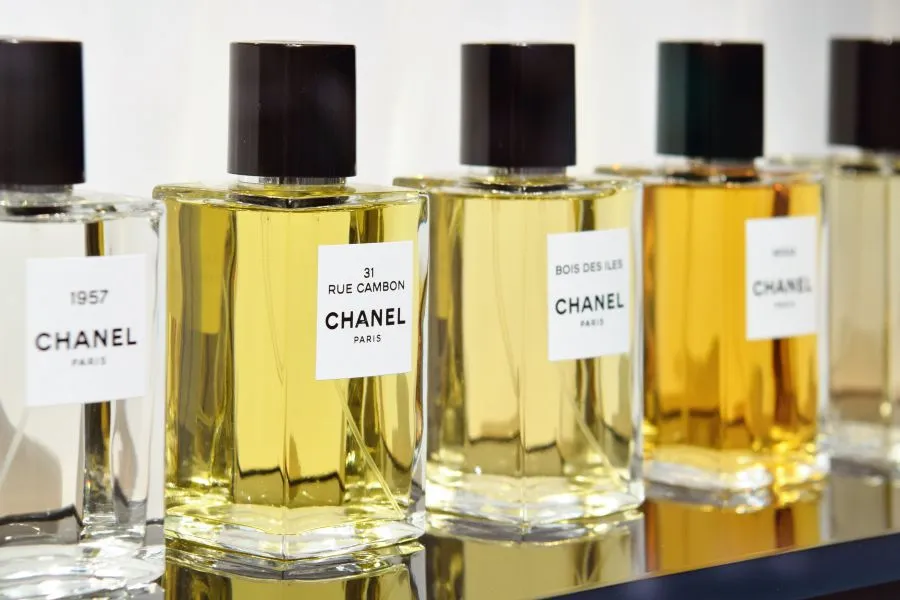 A range of Chanel perfumes on a shelf.